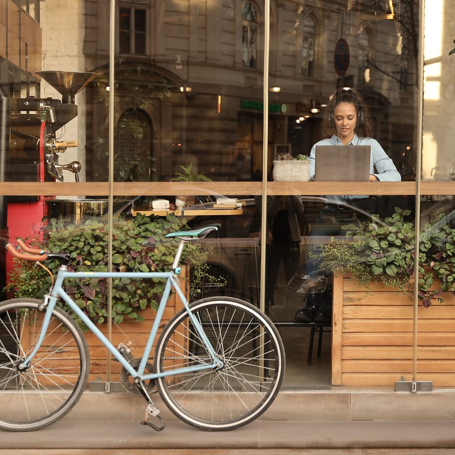 Laptop open on a café table ready for remote work